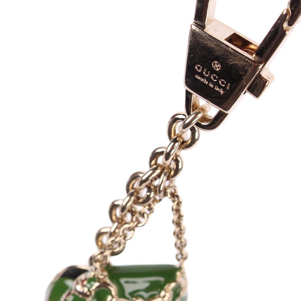 GUCCI CAP AND BAG CHARM - Gold House