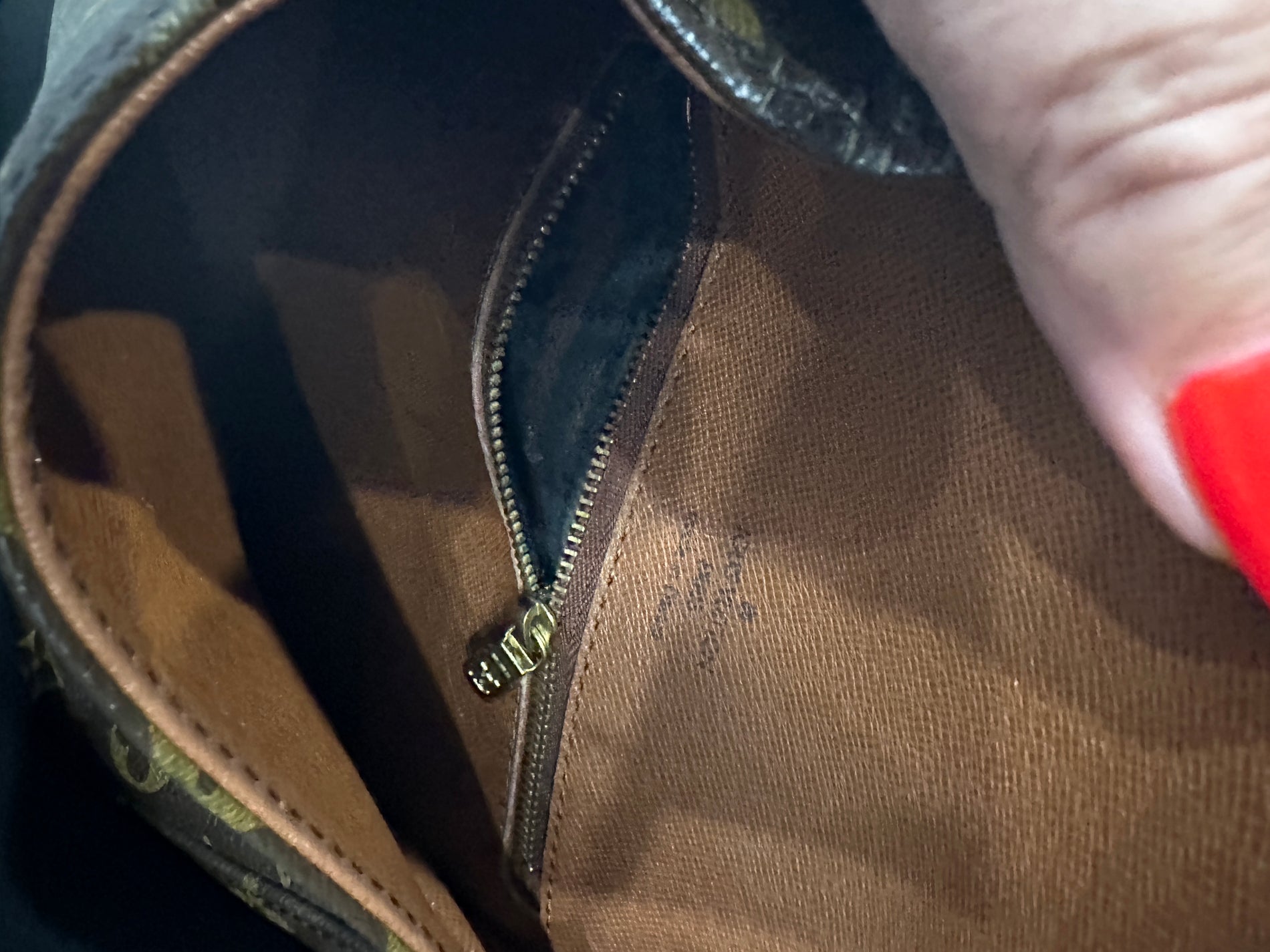 Tarnishing/peeling on mini pochette zipper